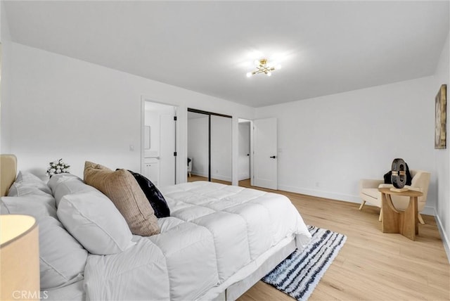 bedroom featuring a closet and light wood-type flooring