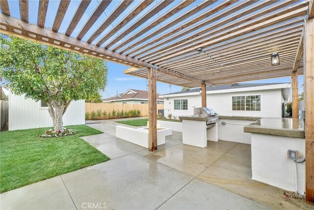 view of patio with an outdoor kitchen, a pergola, and area for grilling