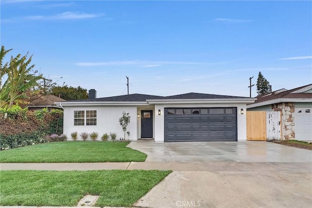 ranch-style home featuring a garage and a front yard