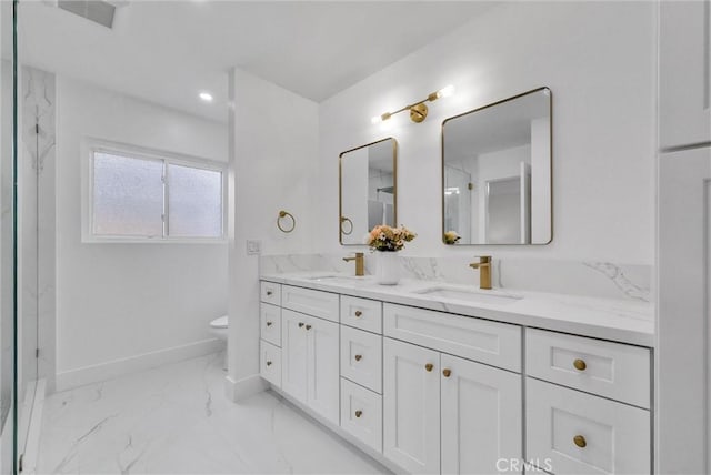 bathroom featuring vanity and toilet