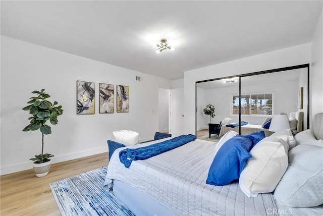 bedroom featuring light hardwood / wood-style floors and a closet