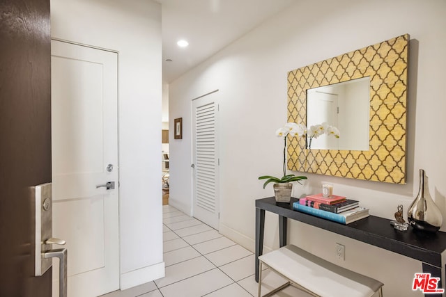 hall featuring light tile patterned floors