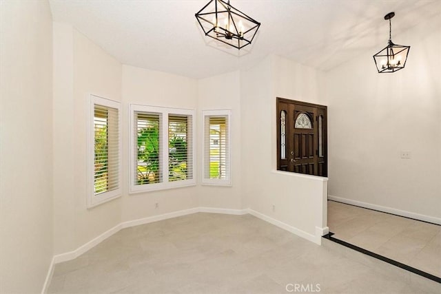 spare room featuring a notable chandelier