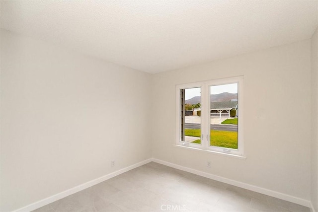 unfurnished room with a mountain view