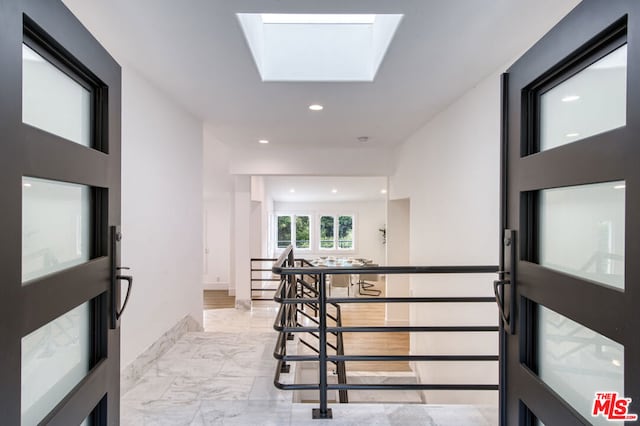 hallway featuring a skylight