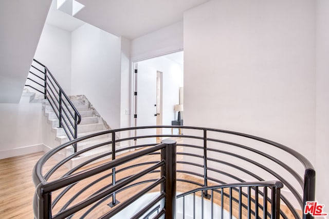 stairs featuring wood-type flooring