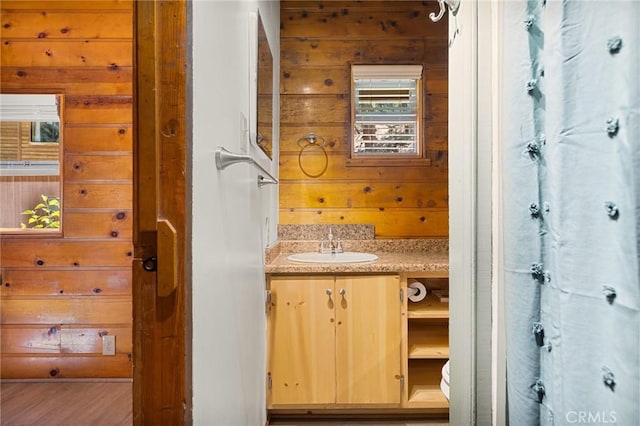 bathroom with vanity and wood walls