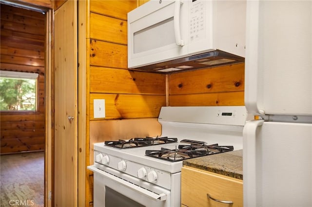 kitchen with white appliances and dark stone counters