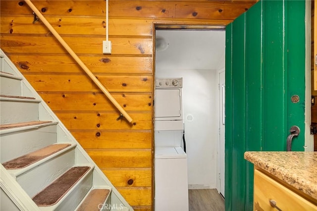 interior space featuring wood-type flooring and stacked washing maching and dryer