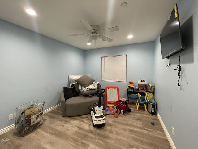 living area with hardwood / wood-style flooring and ceiling fan