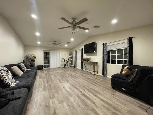 living room featuring lofted ceiling, light hardwood / wood-style flooring, and ceiling fan