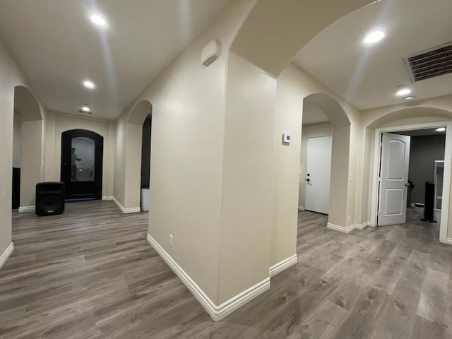 corridor with light hardwood / wood-style flooring