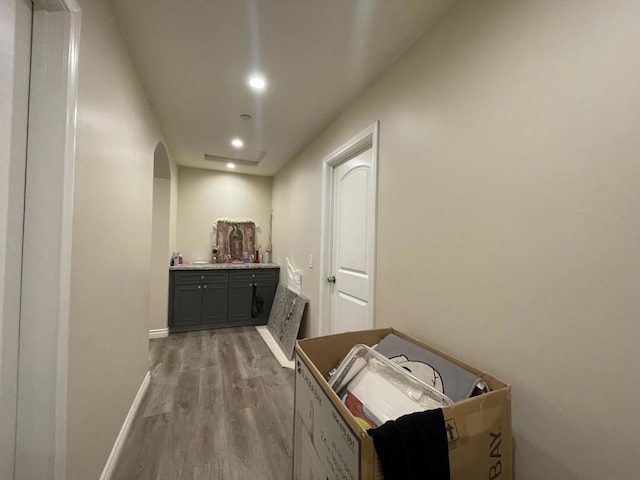 hallway with light hardwood / wood-style floors