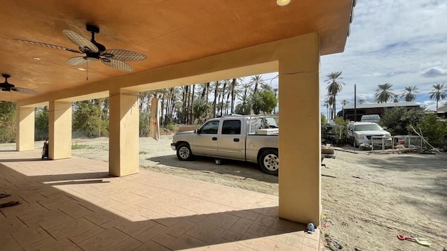 view of car parking featuring ceiling fan