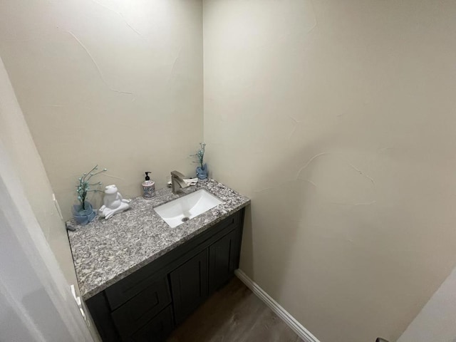 bathroom with vanity and wood-type flooring