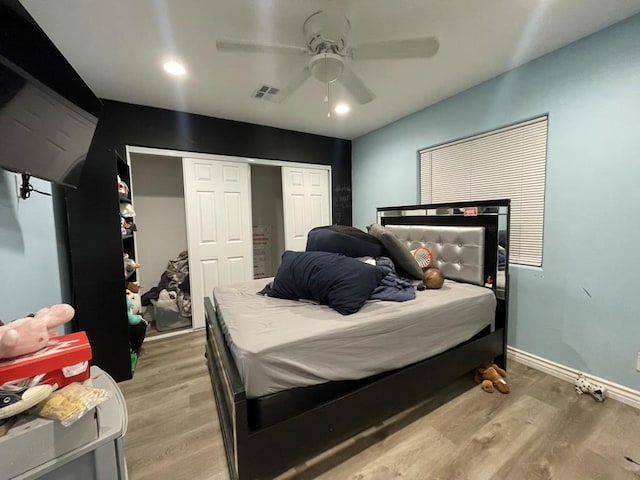 bedroom with light hardwood / wood-style floors, a closet, and ceiling fan