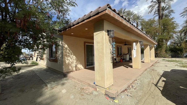 back of property featuring a patio and ceiling fan