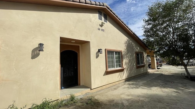 property entrance featuring a patio