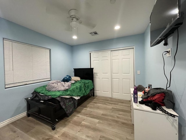 bedroom featuring a closet, ceiling fan, and light wood-type flooring