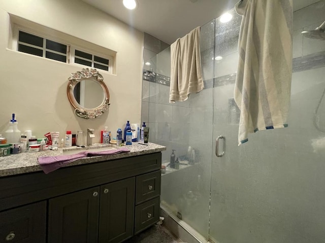 bathroom featuring vanity and a shower with shower door