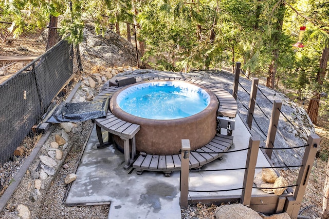 view of swimming pool with an outdoor hot tub