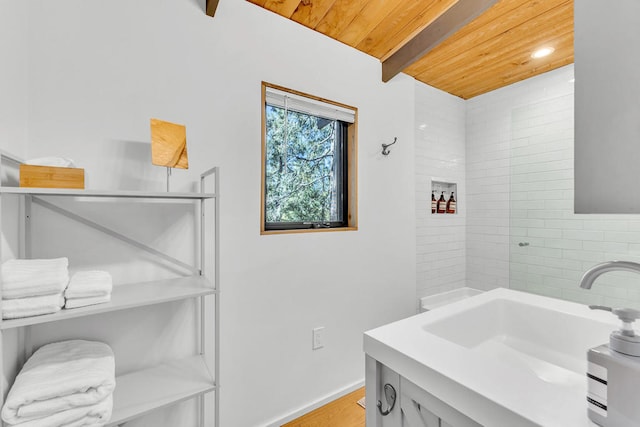 bathroom featuring beam ceiling, vanity, hardwood / wood-style floors, and wood ceiling