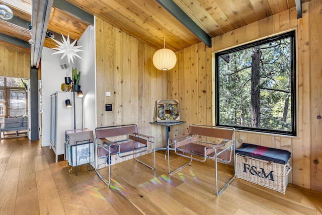 misc room with wood-type flooring, wooden ceiling, wooden walls, and beamed ceiling