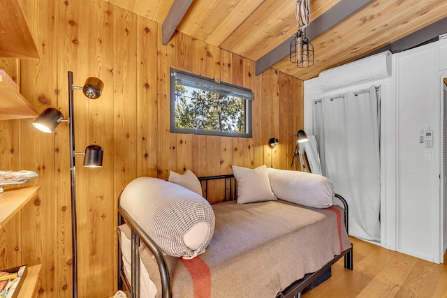 bedroom with wood ceiling, light hardwood / wood-style flooring, beam ceiling, wooden walls, and a wall mounted air conditioner