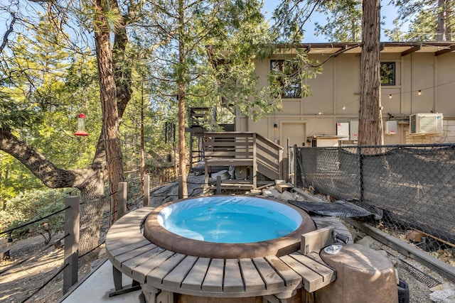 view of swimming pool featuring an outdoor hot tub