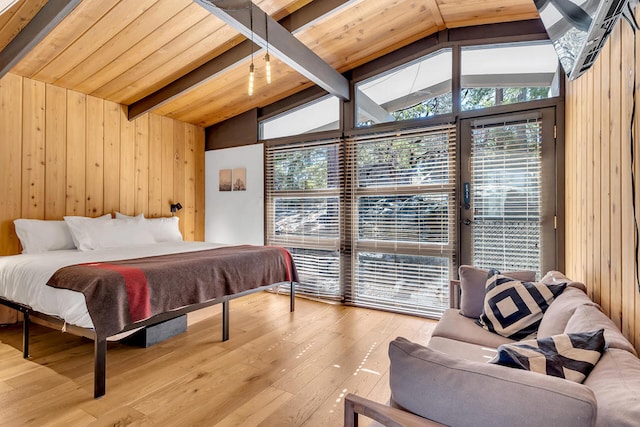 bedroom with lofted ceiling with beams, access to exterior, light hardwood / wood-style floors, and wood walls