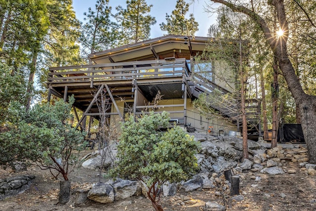 rear view of property with a wooden deck