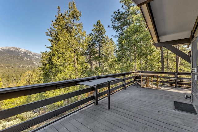 wooden deck with a mountain view