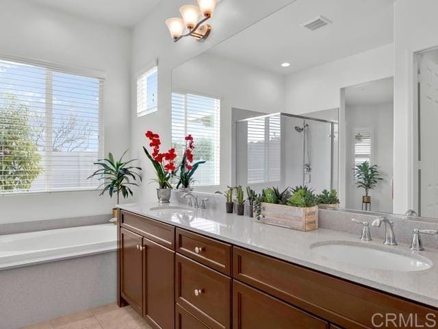 bathroom featuring vanity, a notable chandelier, tile patterned floors, and separate shower and tub