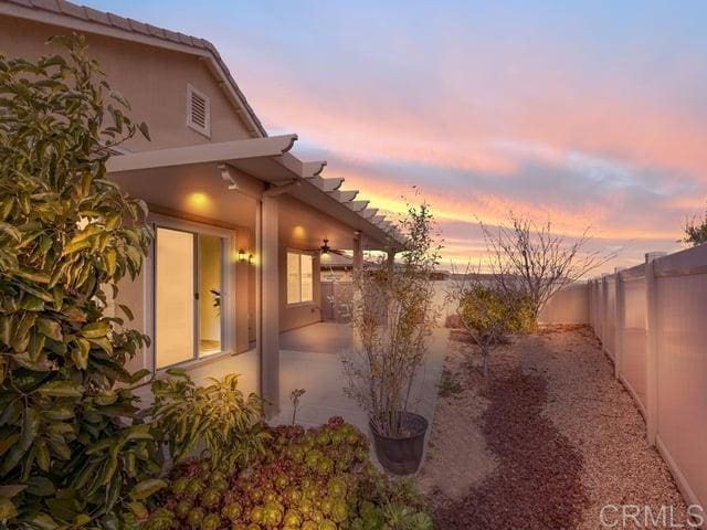 yard at dusk featuring a patio area