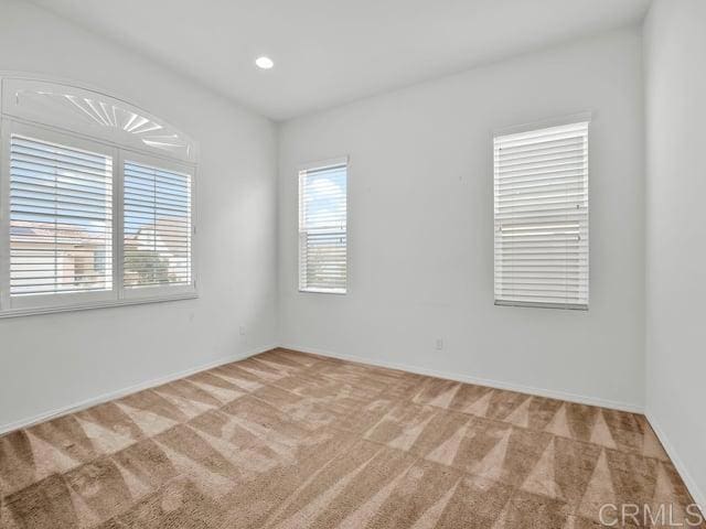 empty room featuring light colored carpet