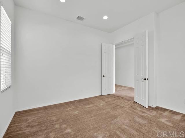 empty room with light colored carpet