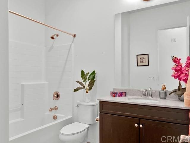 full bathroom with shower / bathing tub combination, vanity, and toilet