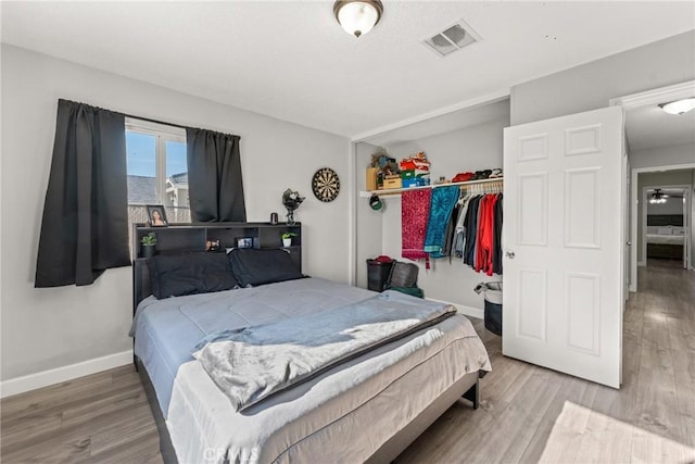 bedroom featuring wood-type flooring and a closet