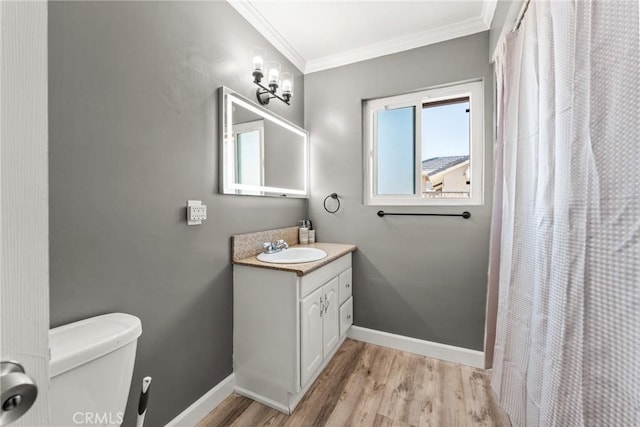 bathroom featuring toilet, crown molding, vanity, a shower with shower curtain, and hardwood / wood-style floors