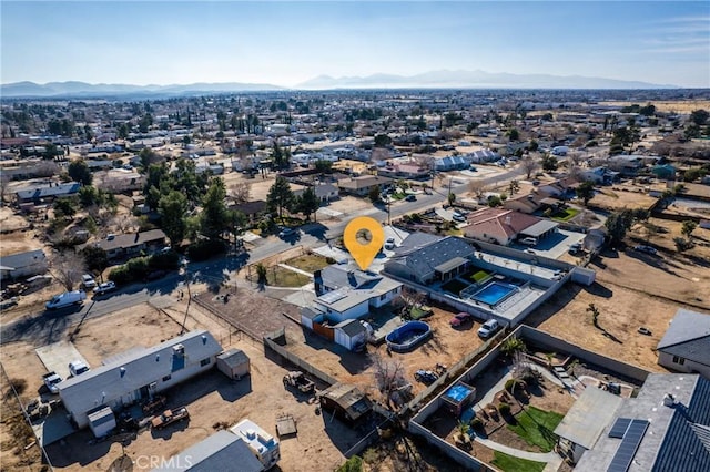 birds eye view of property featuring a mountain view