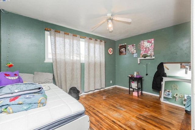 bedroom with hardwood / wood-style floors and ceiling fan