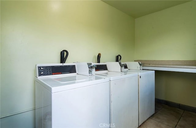 washroom featuring washing machine and clothes dryer and light tile patterned flooring