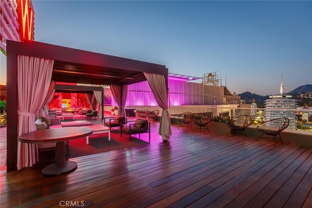 deck at dusk with an outdoor living space