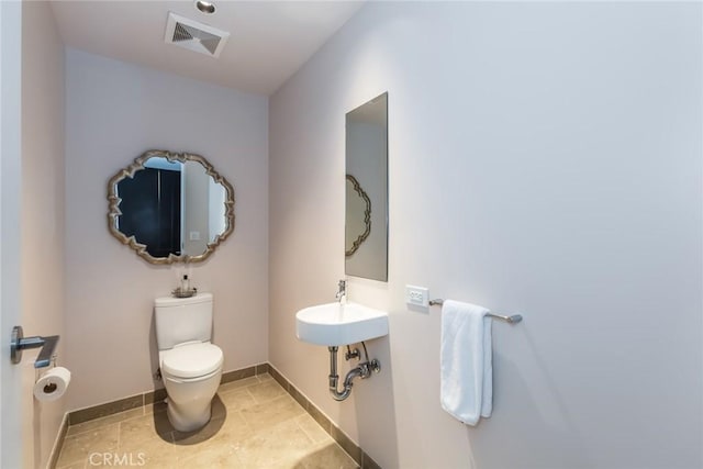 bathroom with tile patterned flooring, sink, and toilet