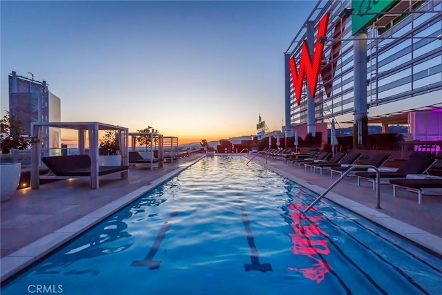 pool at dusk with a patio