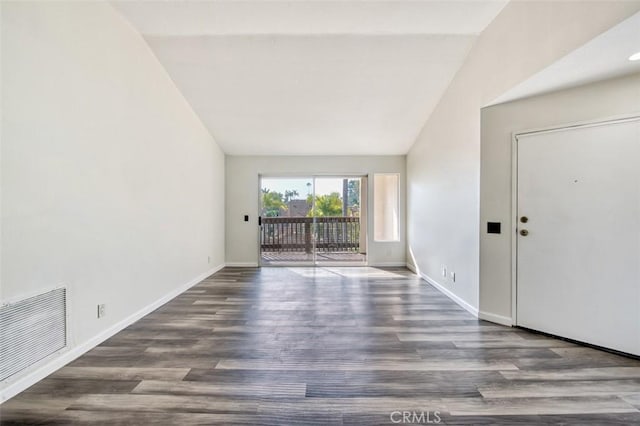 unfurnished living room with dark wood-type flooring and lofted ceiling