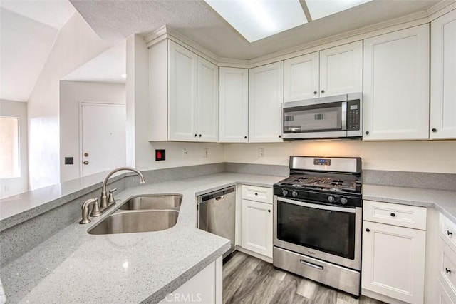 kitchen featuring appliances with stainless steel finishes, light stone countertops, and sink