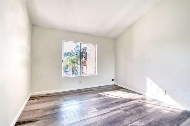 spare room with hardwood / wood-style floors