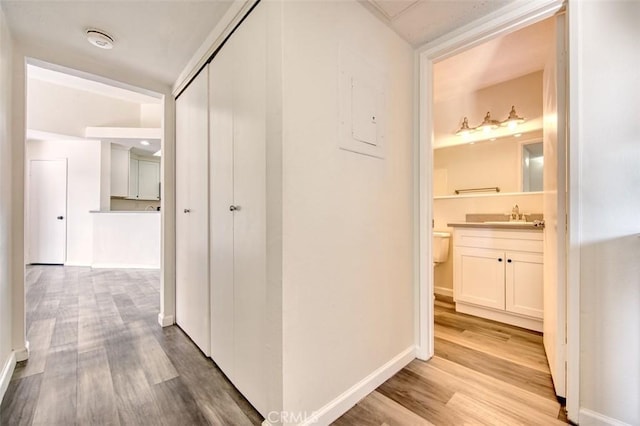 25246 San Michele, Laguna Niguel, CA 92677 - corridor featuring wood finished floors, baseboards, and a sink