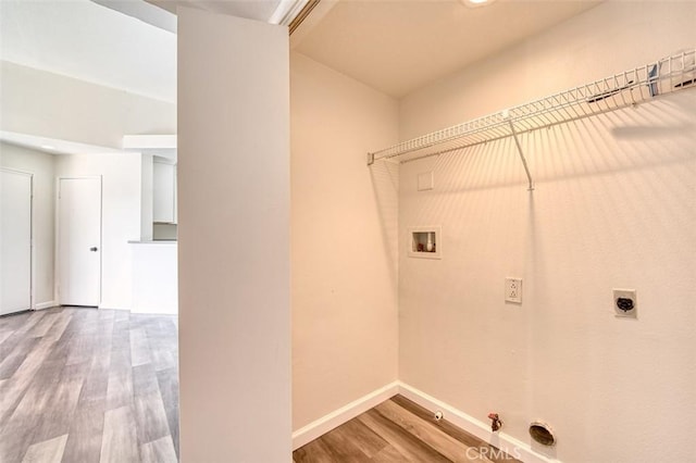 washroom featuring gas dryer hookup, wood-type flooring, hookup for an electric dryer, and hookup for a washing machine